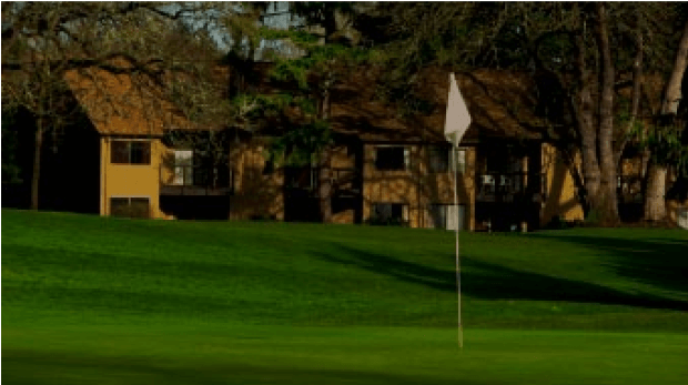 A screenshot of a golf course with a multi-family structure in the background